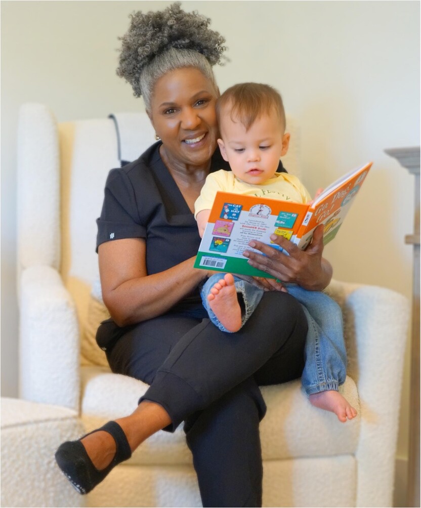 Stephaney reading with a young child