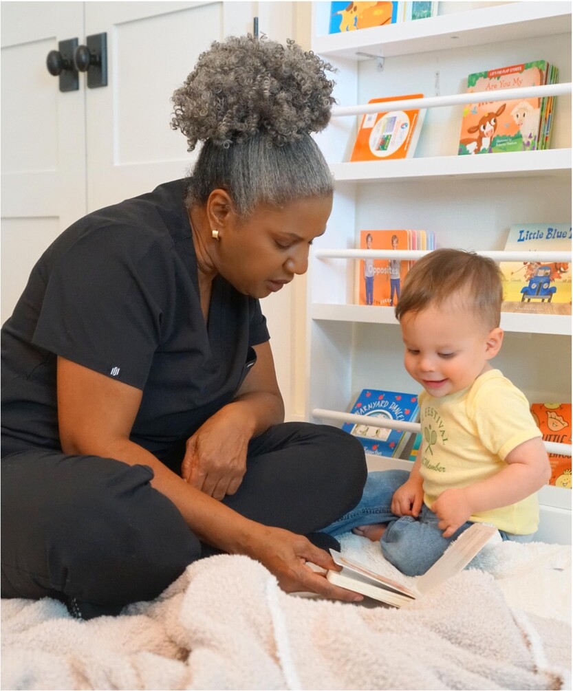 Stephaney sharing a book with a child